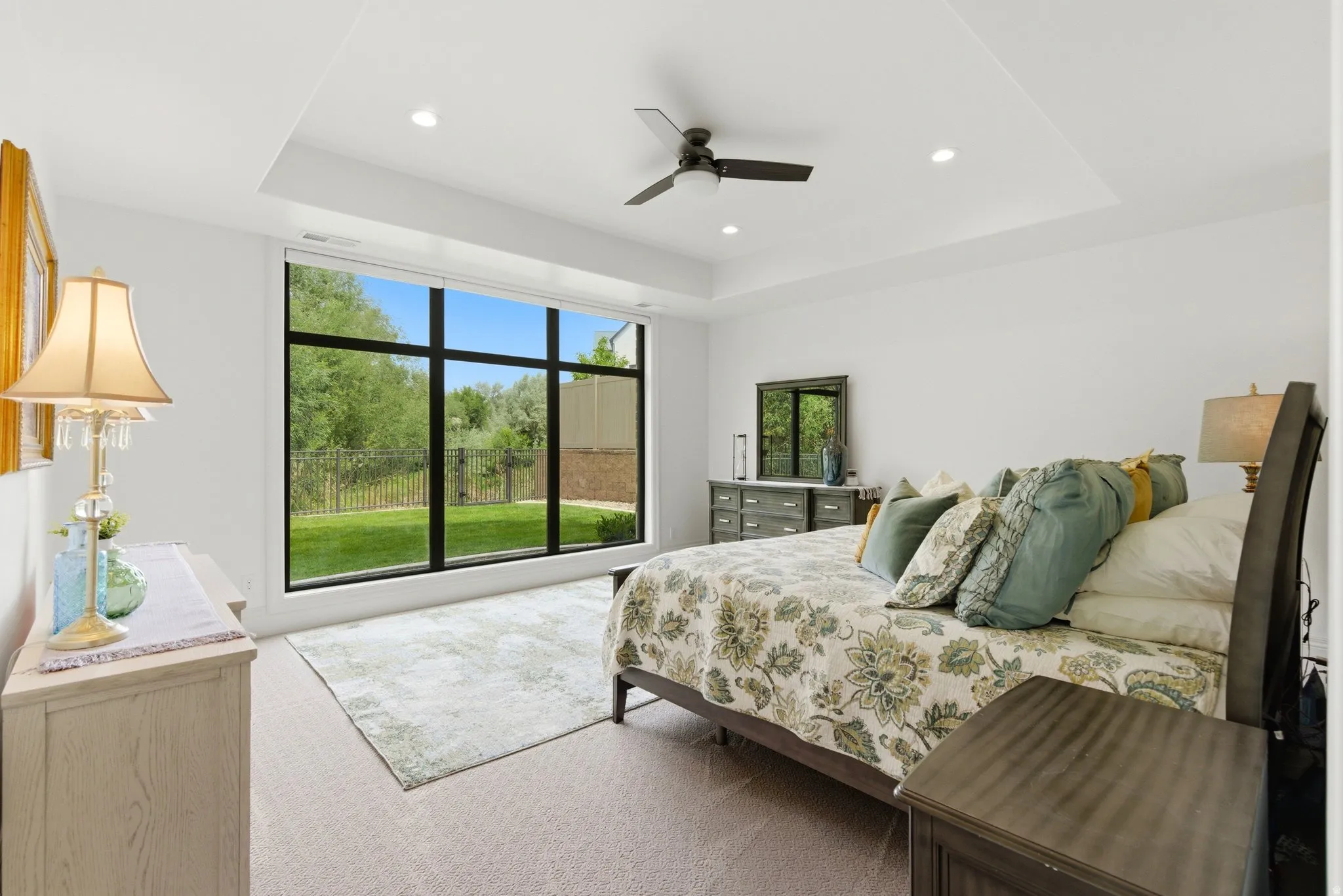 Expansive floor-to-ceiling window showcasing exterior landscaping in Daylight Basement