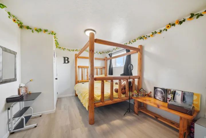 Bedroom with light wood finished floors and baseboards