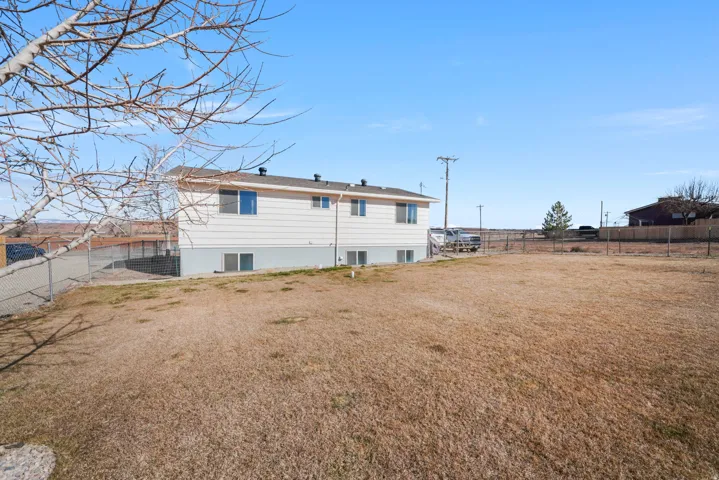 Rear view of property featuring a fenced backyard