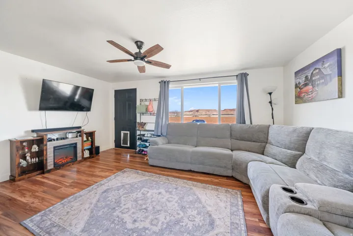 Living area featuring wood finished floors and ceiling fan