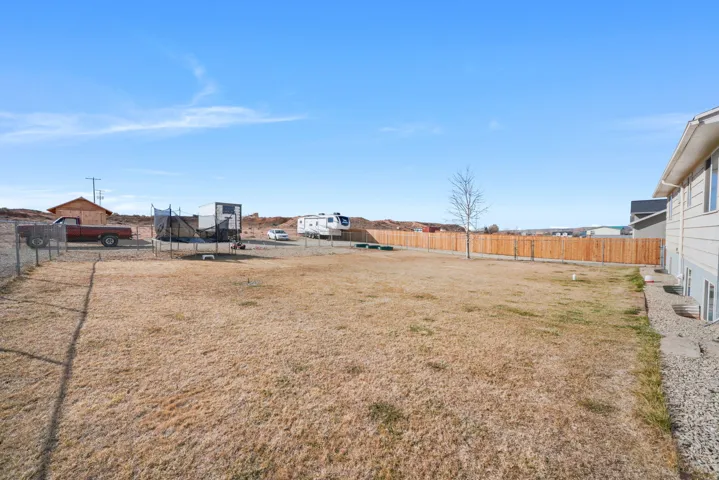 Fenced backyard with a trampoline