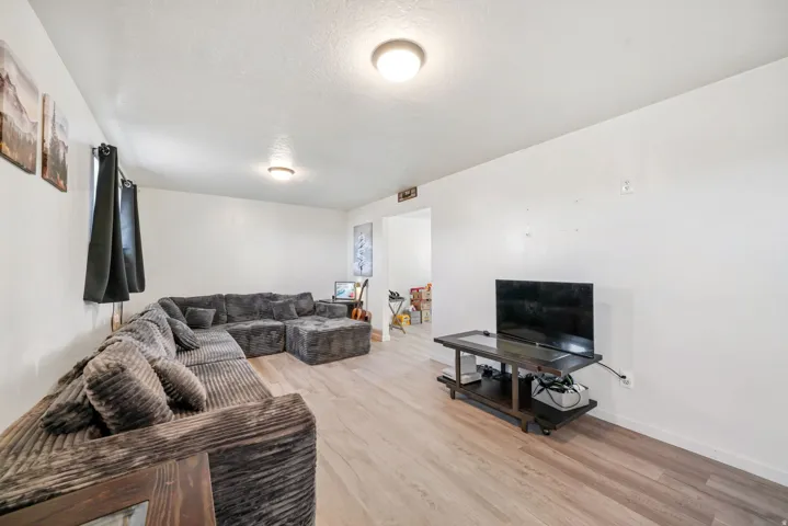 Living area with light wood-type flooring and baseboards