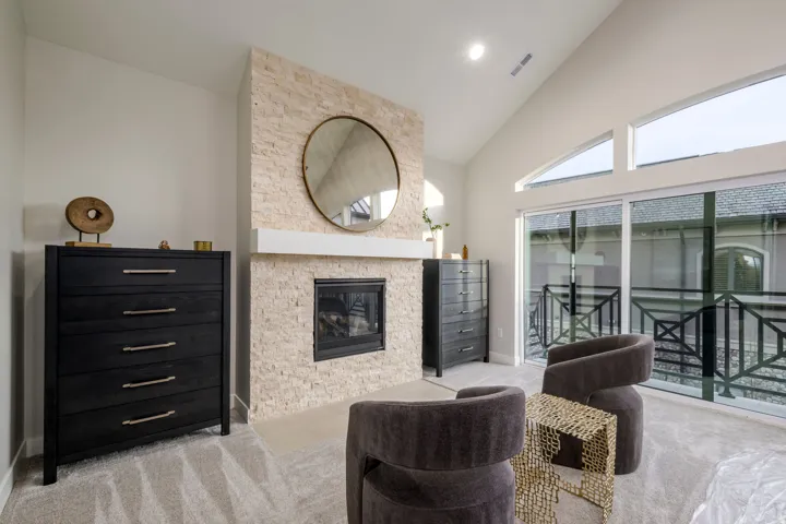 Sitting room with carpet floors, a fireplace, vaulted ceiling, and recessed lighting