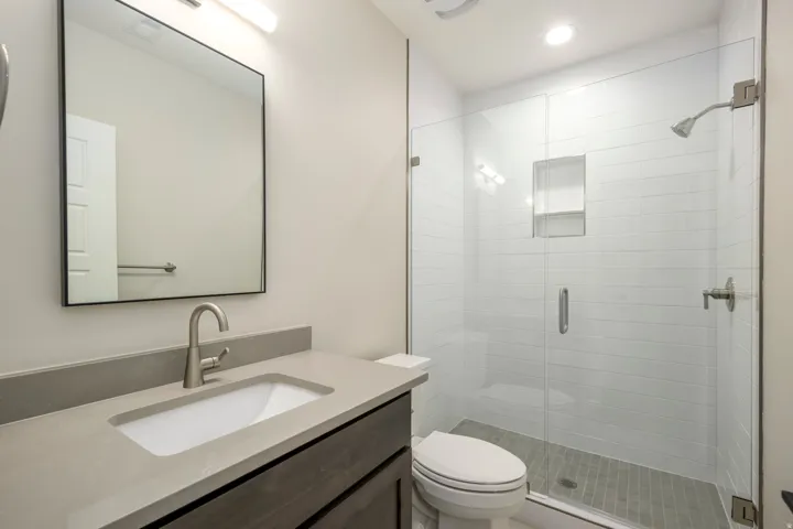 Full bathroom featuring a shower stall, vanity, and recessed lighting