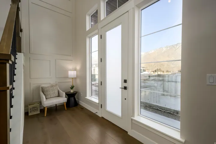 Doorway featuring a decorative wall, wood finished floors, healthy amount of natural light, and a mountain view
