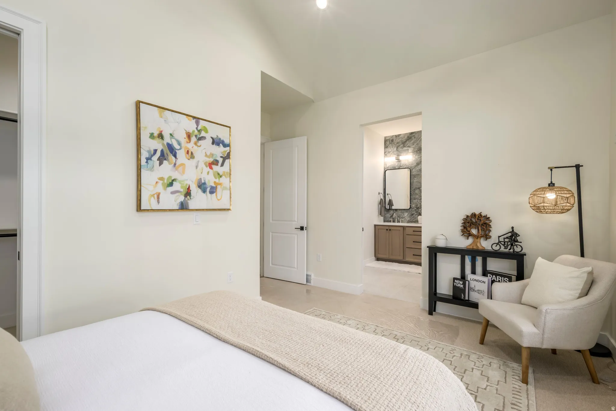 Bedroom featuring ensuite bath and lofted ceiling