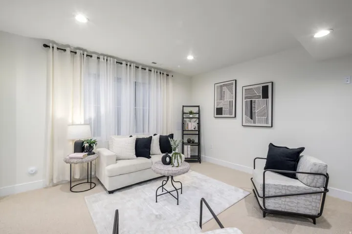 Living area featuring light carpet and recessed lighting