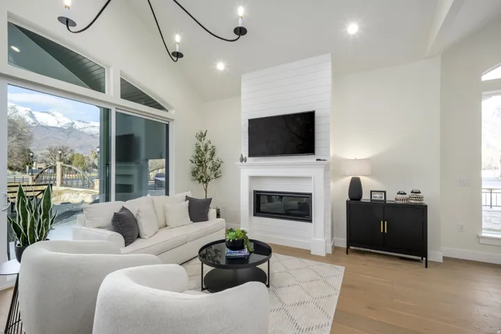 Living room featuring a mountain view, healthy amount of natural light, a fireplace, recessed lighting, and wood finished floors