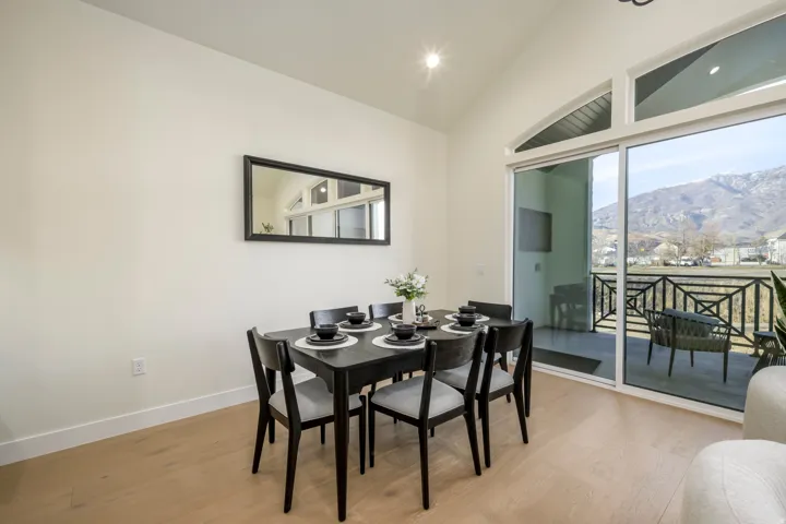 Dining area featuring light wood-type flooring, recessed lighting, and vaulted ceiling