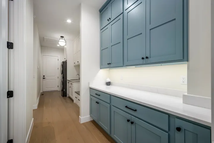 Hall with light wood finished floors and recessed lighting