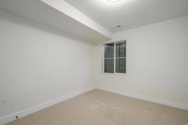 Spare room with baseboards and carpet floors