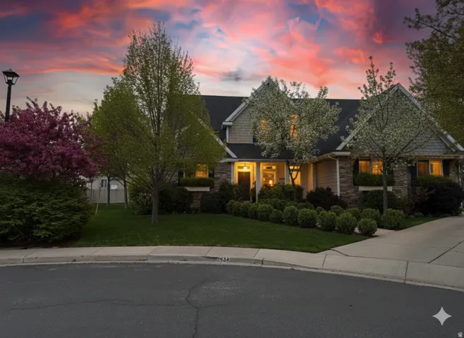 View of front facade with a front yard and stone siding