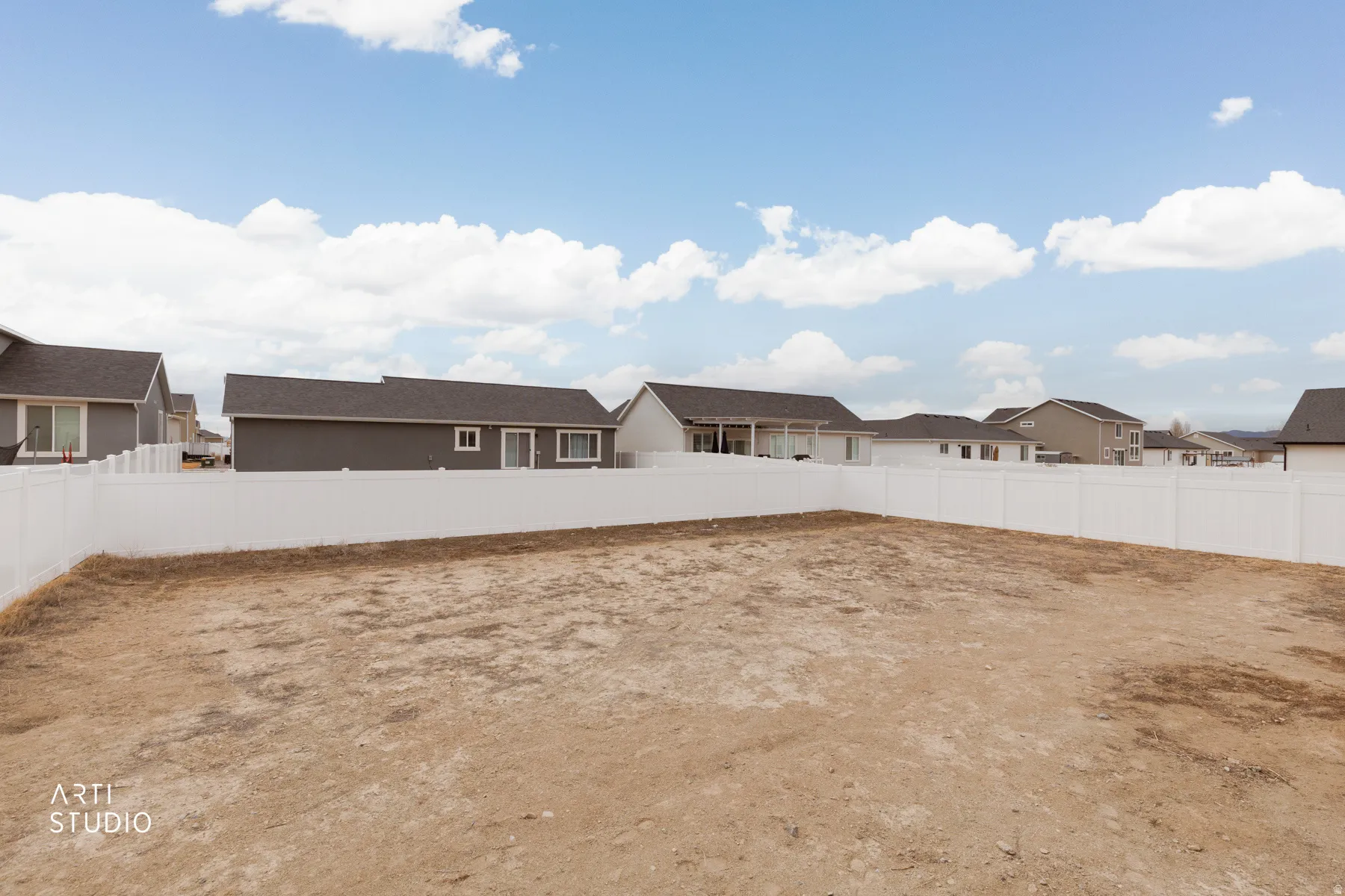Fenced backyard featuring a residential view
