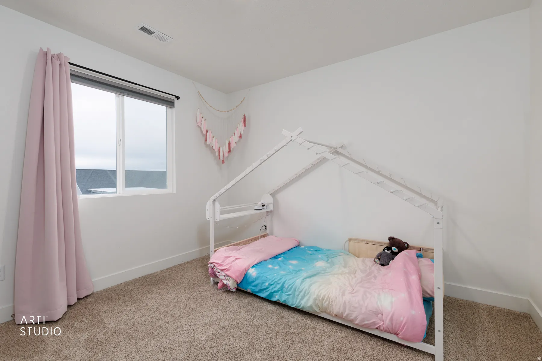 Carpeted bedroom featuring baseboards