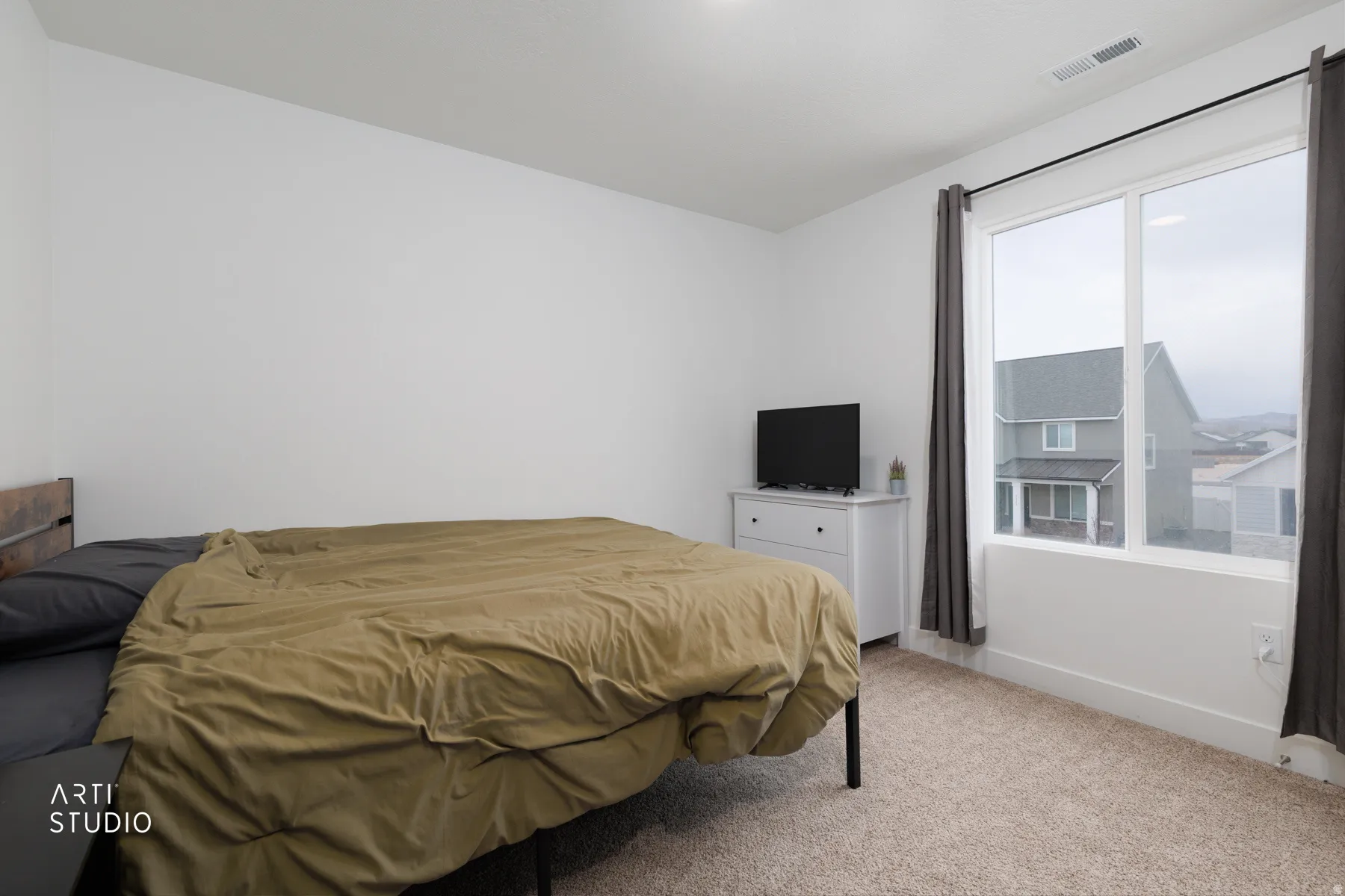 Carpeted bedroom featuring baseboards