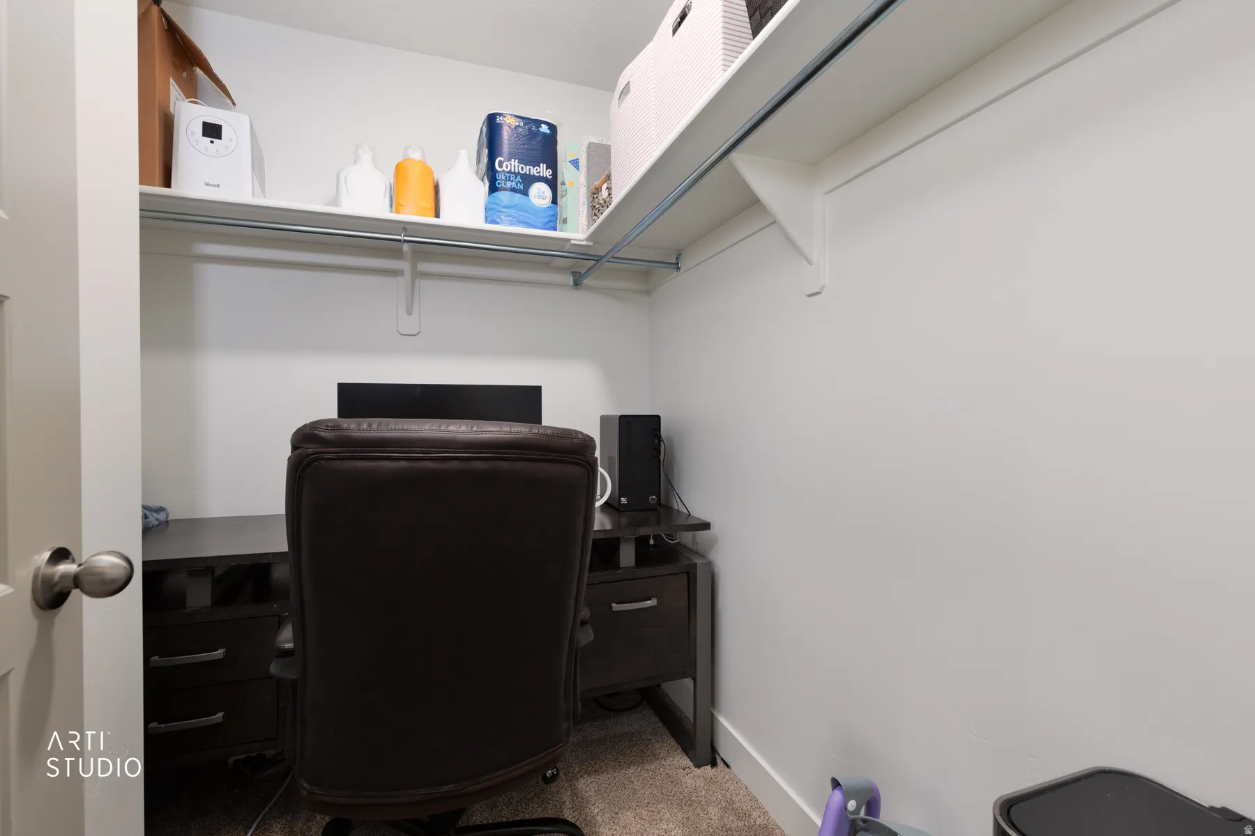 Carpeted home office featuring baseboards