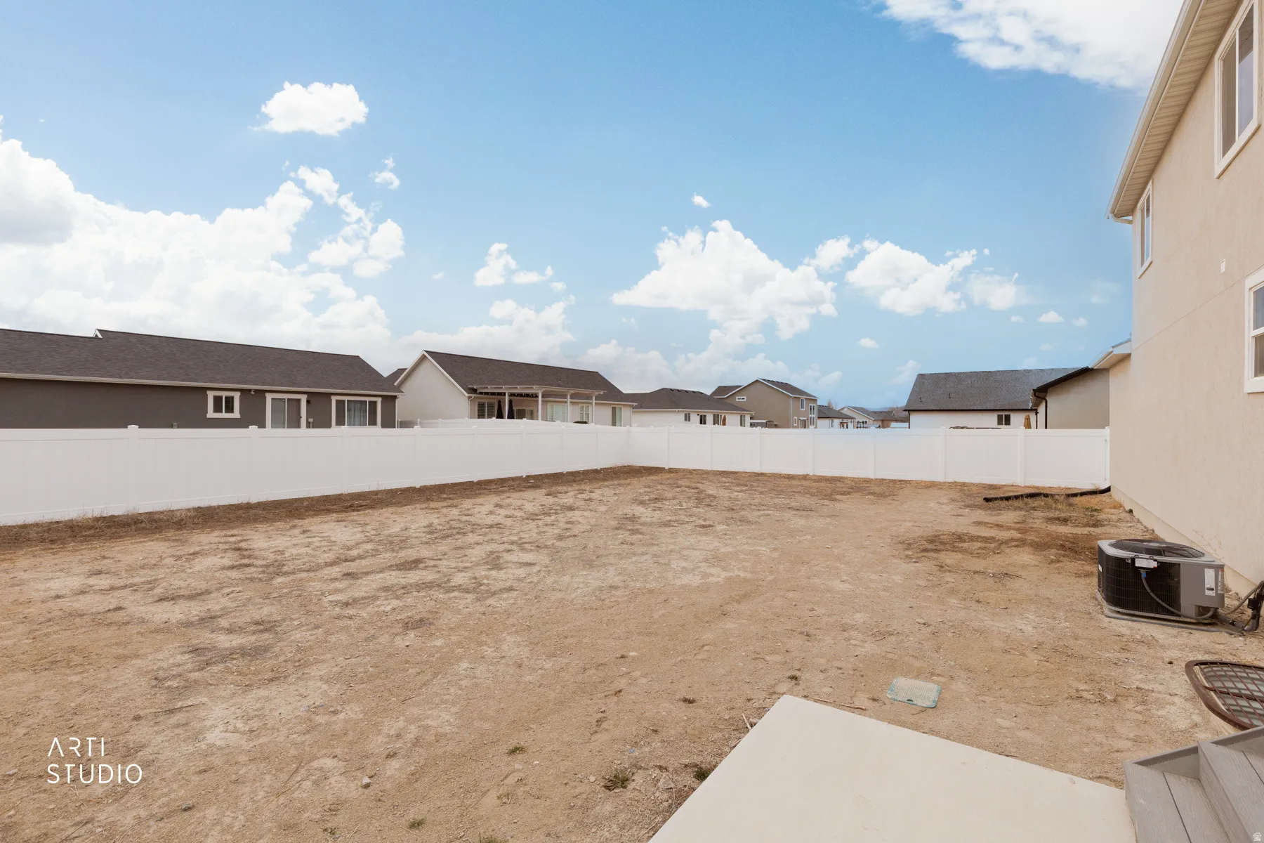 Fenced backyard with a residential view