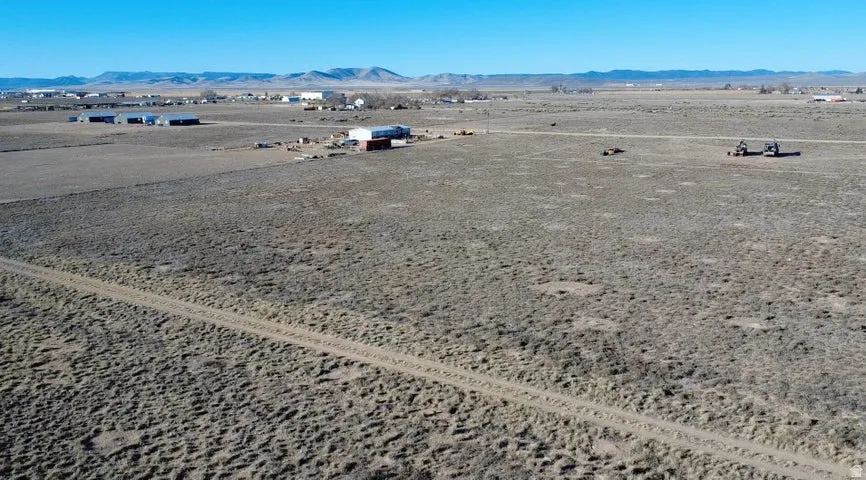 Aerial view of a mountain backdrop and a desert landscape