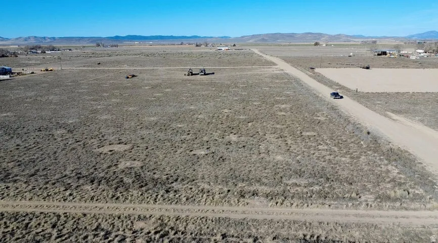 Aerial view of sparsely populated area with a mountain backdrop and a desert landscape