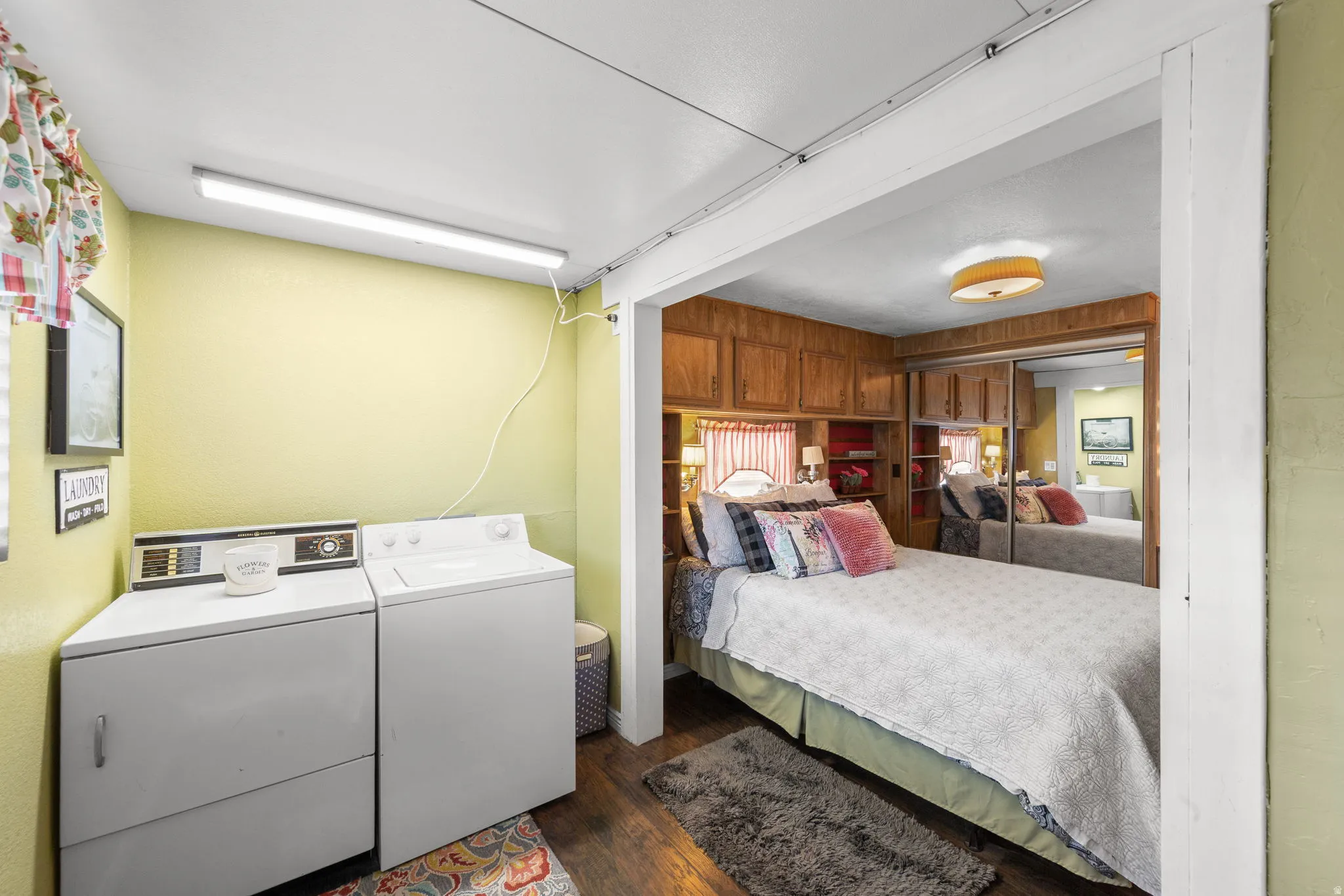 Bedroom featuring dark wood-style floors and washing machine and clothes dryer