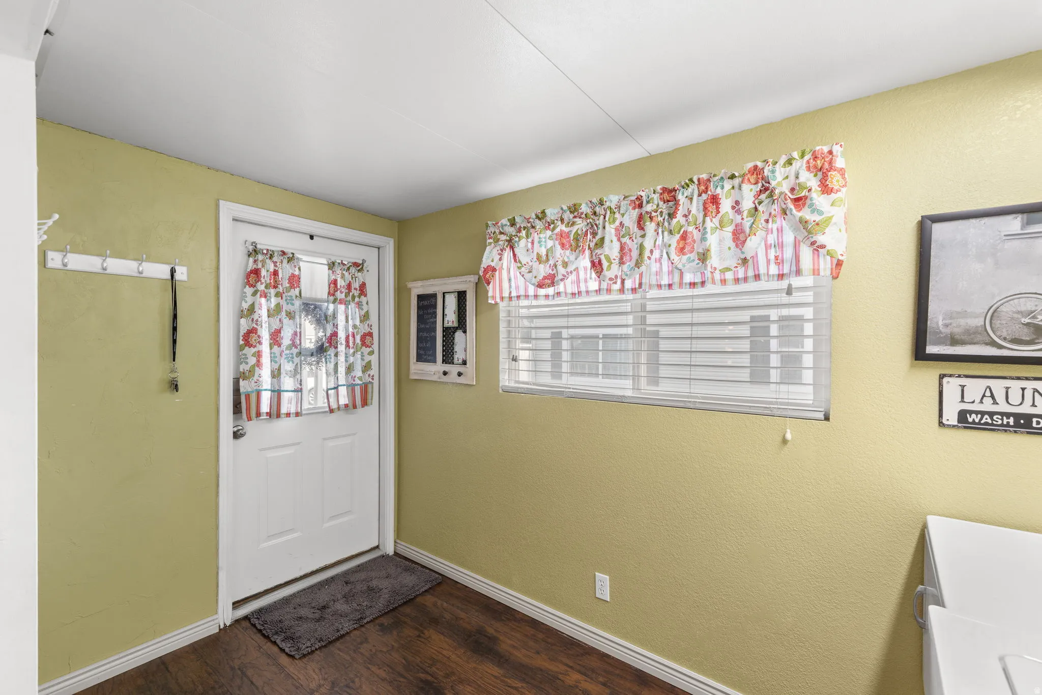 Foyer featuring dark wood finished floors and a textured wall