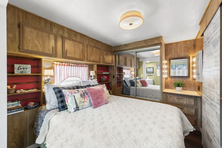 Bedroom featuring wooden walls and a closet