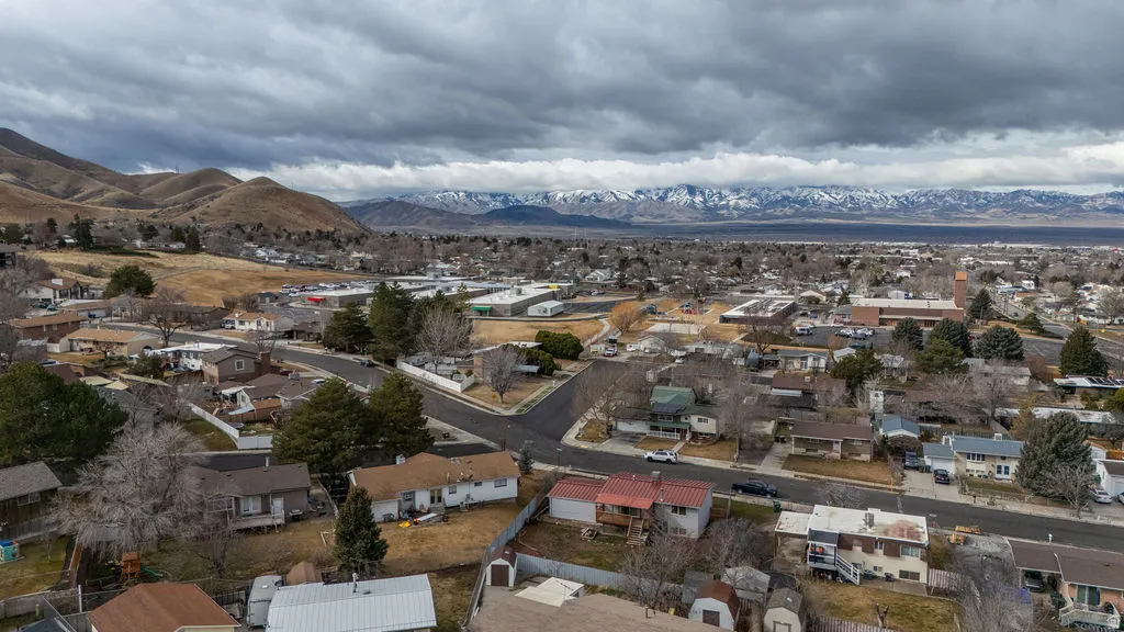 Aerial perspective of suburban area with a mountainous background