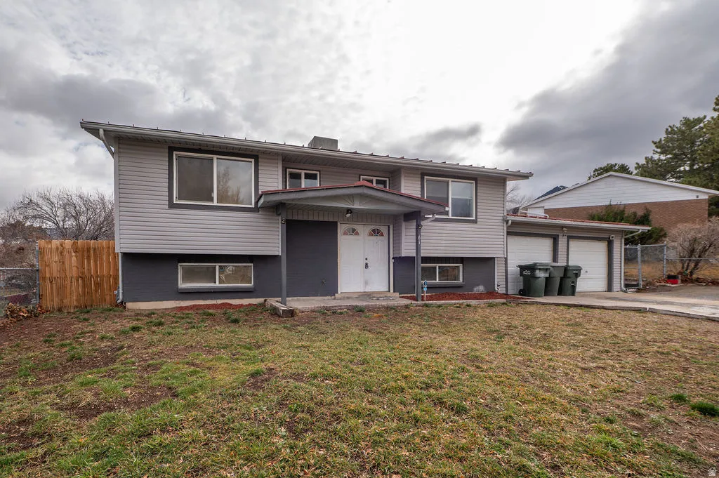 Split foyer home featuring a garage and driveway
