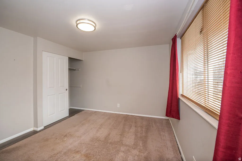 Unfurnished bedroom with carpet floors and a closet