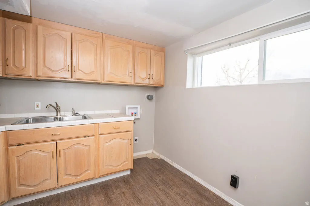 Laundry room featuring cabinet space, washer hookup, dark wood finished floors, and hookup for an electric dryer