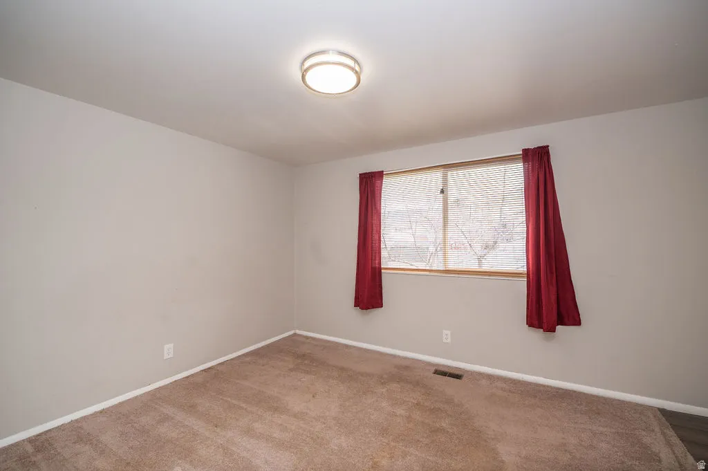 Empty room with baseboards and carpet floors
