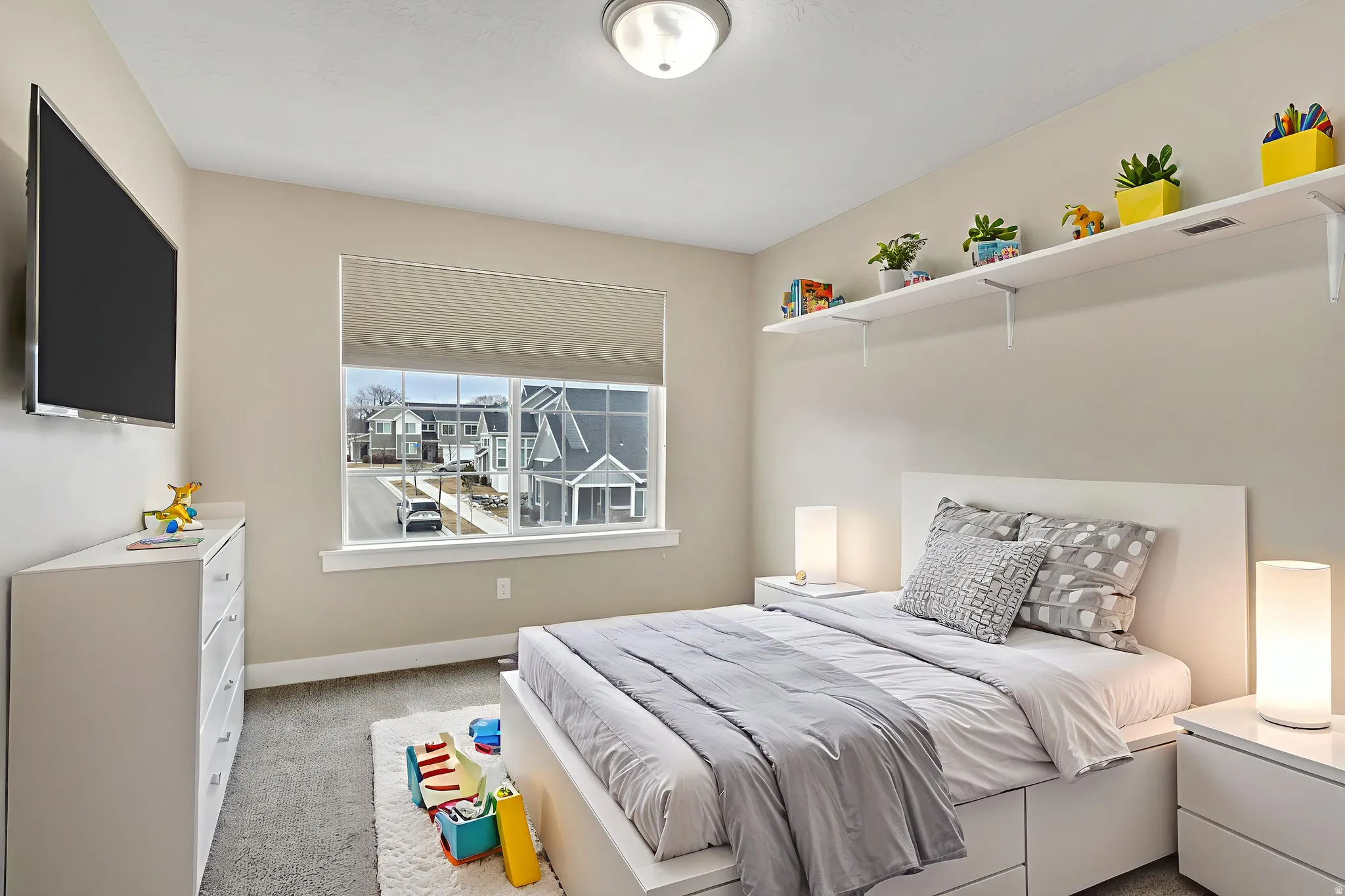 Bedroom featuring light colored carpet and baseboards