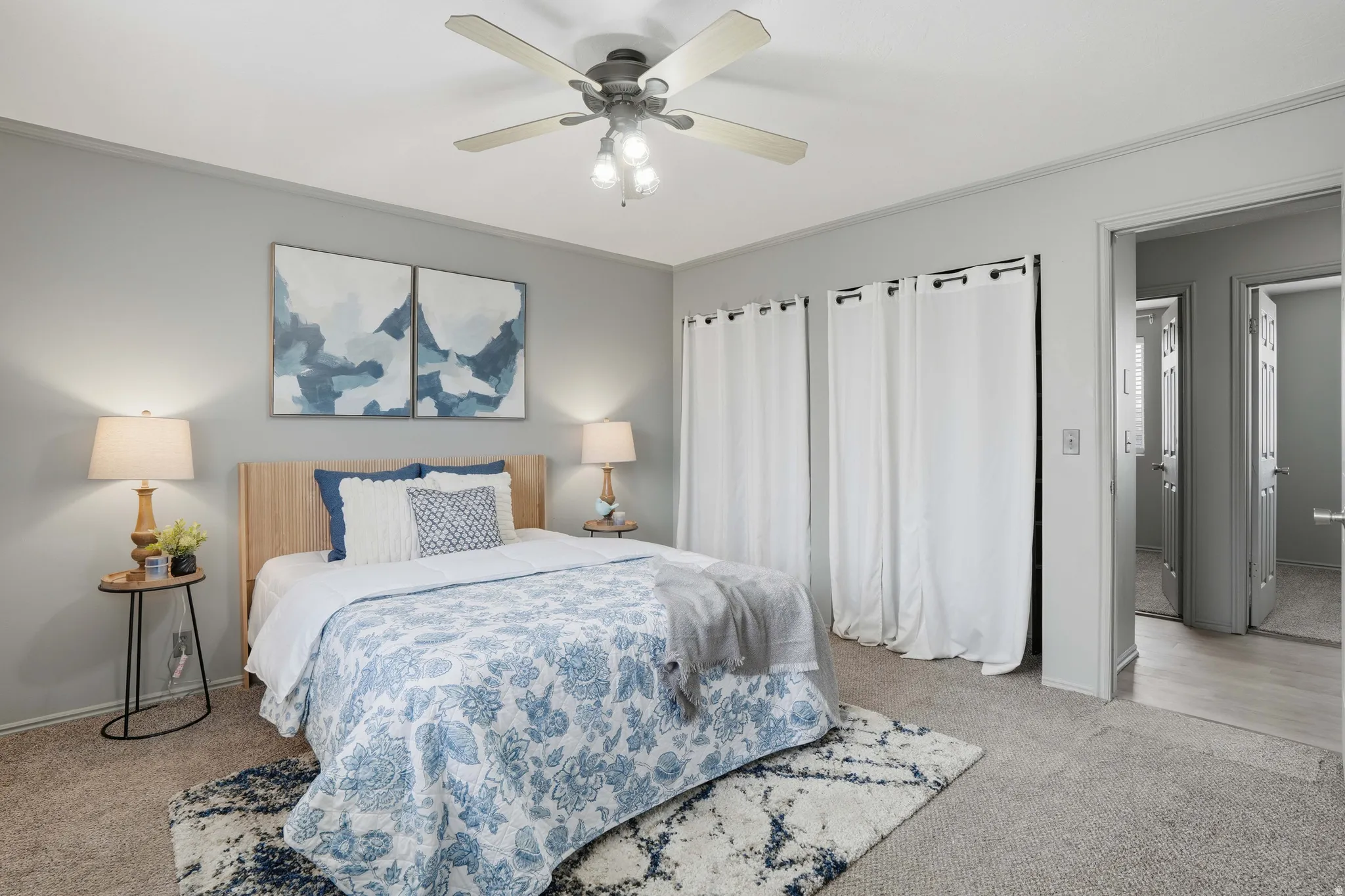 Bedroom featuring light carpet and a ceiling fan