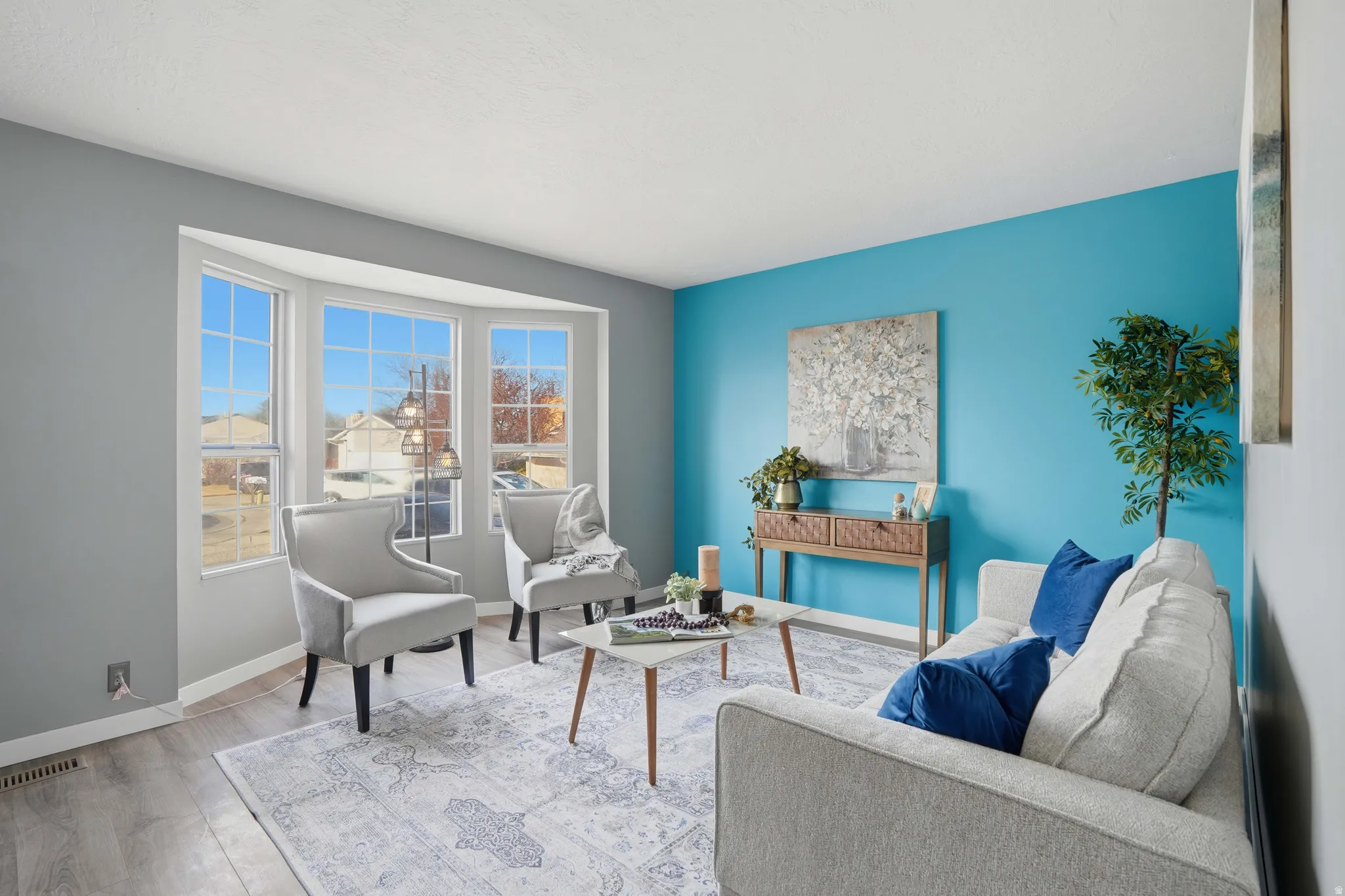 Sitting room with wood finished floors and baseboards