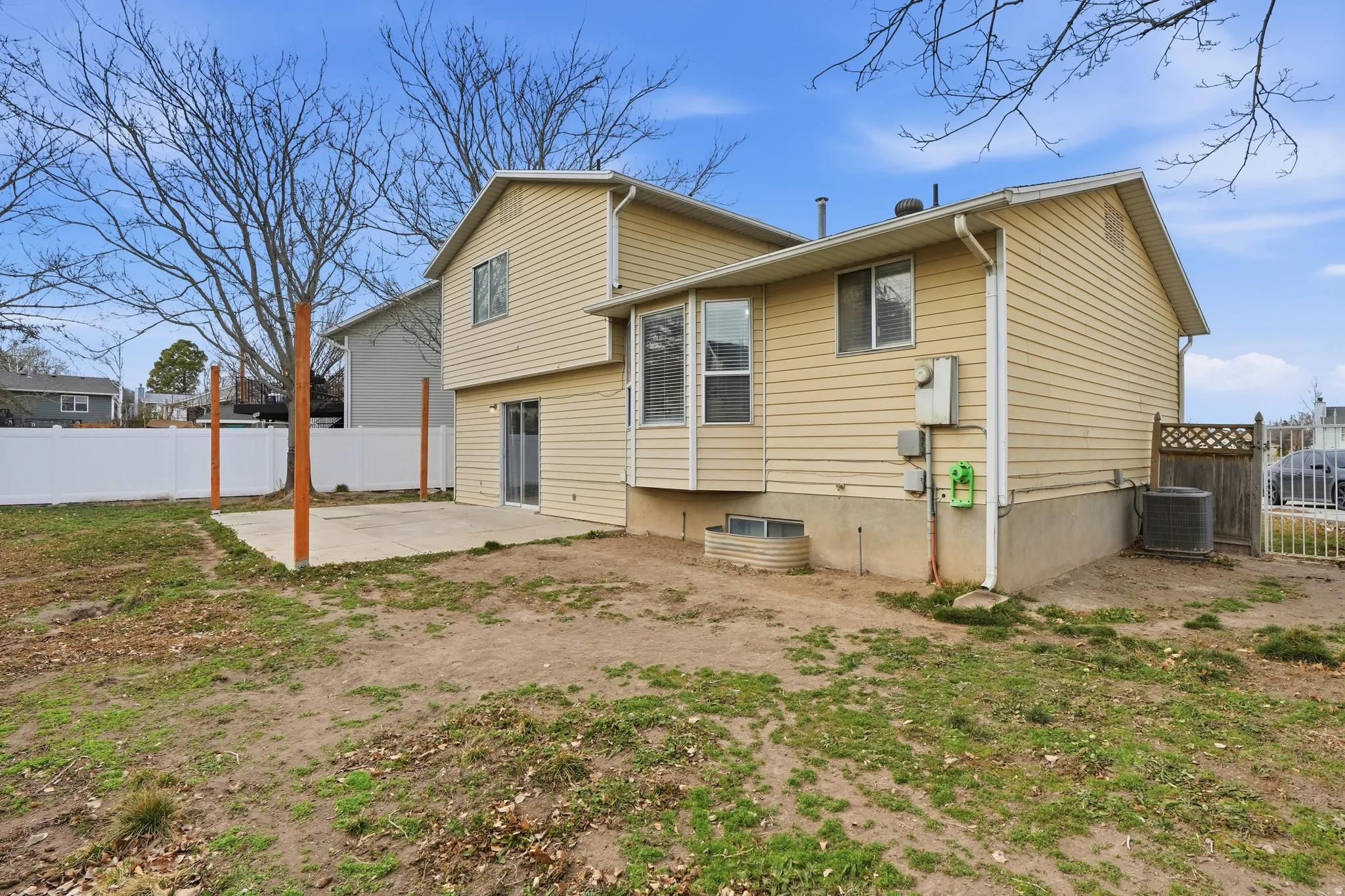 Back of property featuring a fenced backyard and a patio area