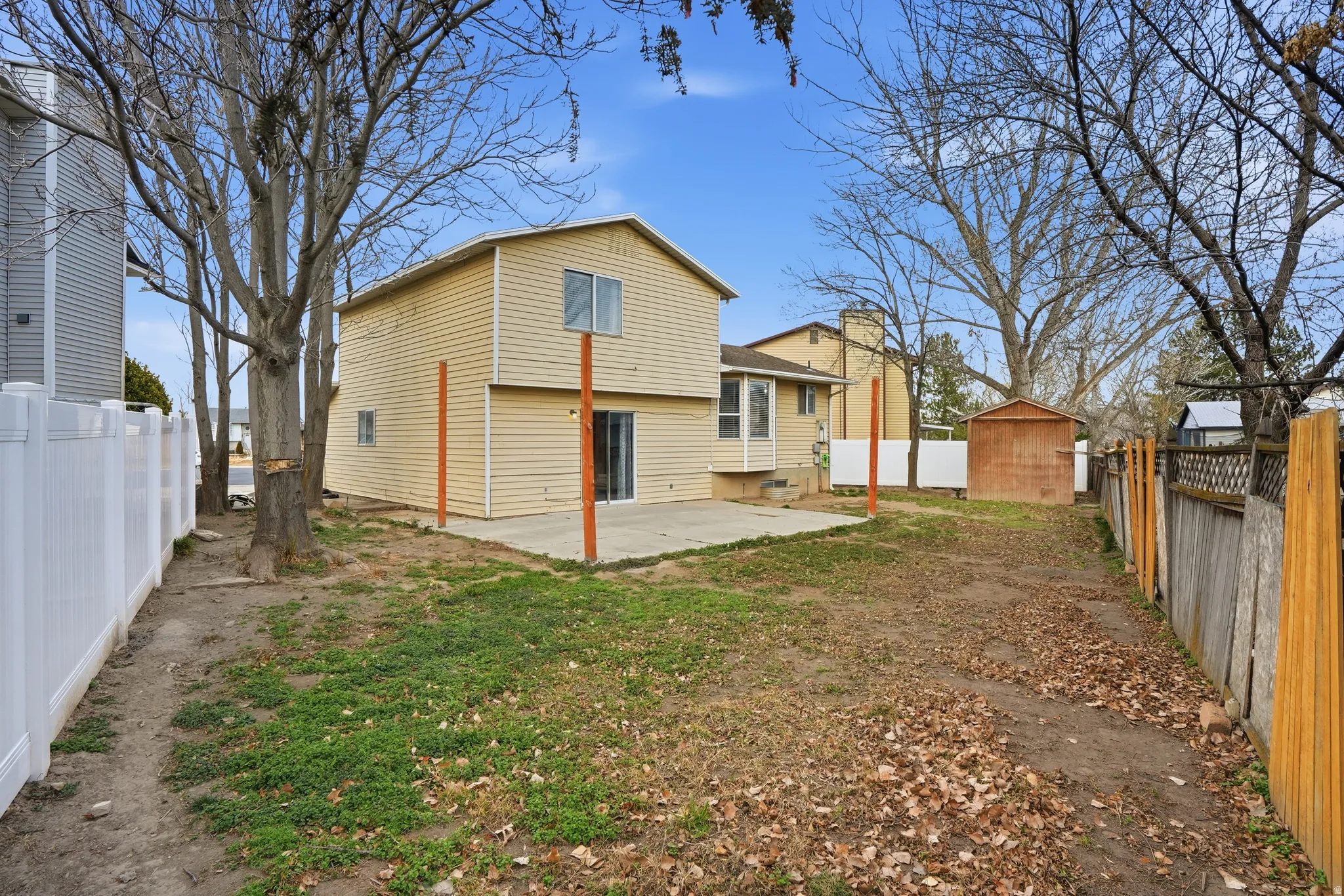 Back of property featuring a patio and a fenced backyard