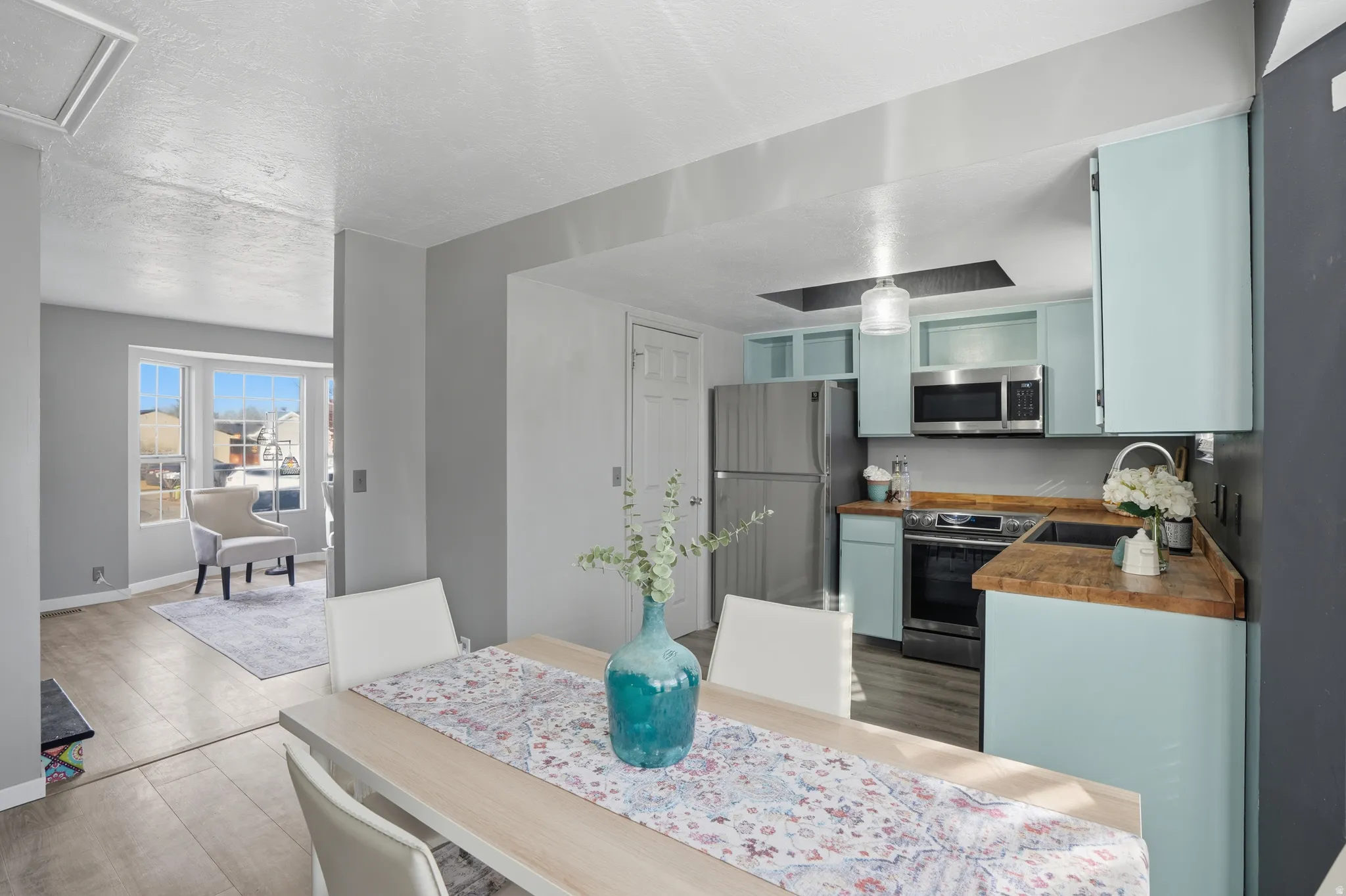 Dining room with wood finished floors and a textured ceiling