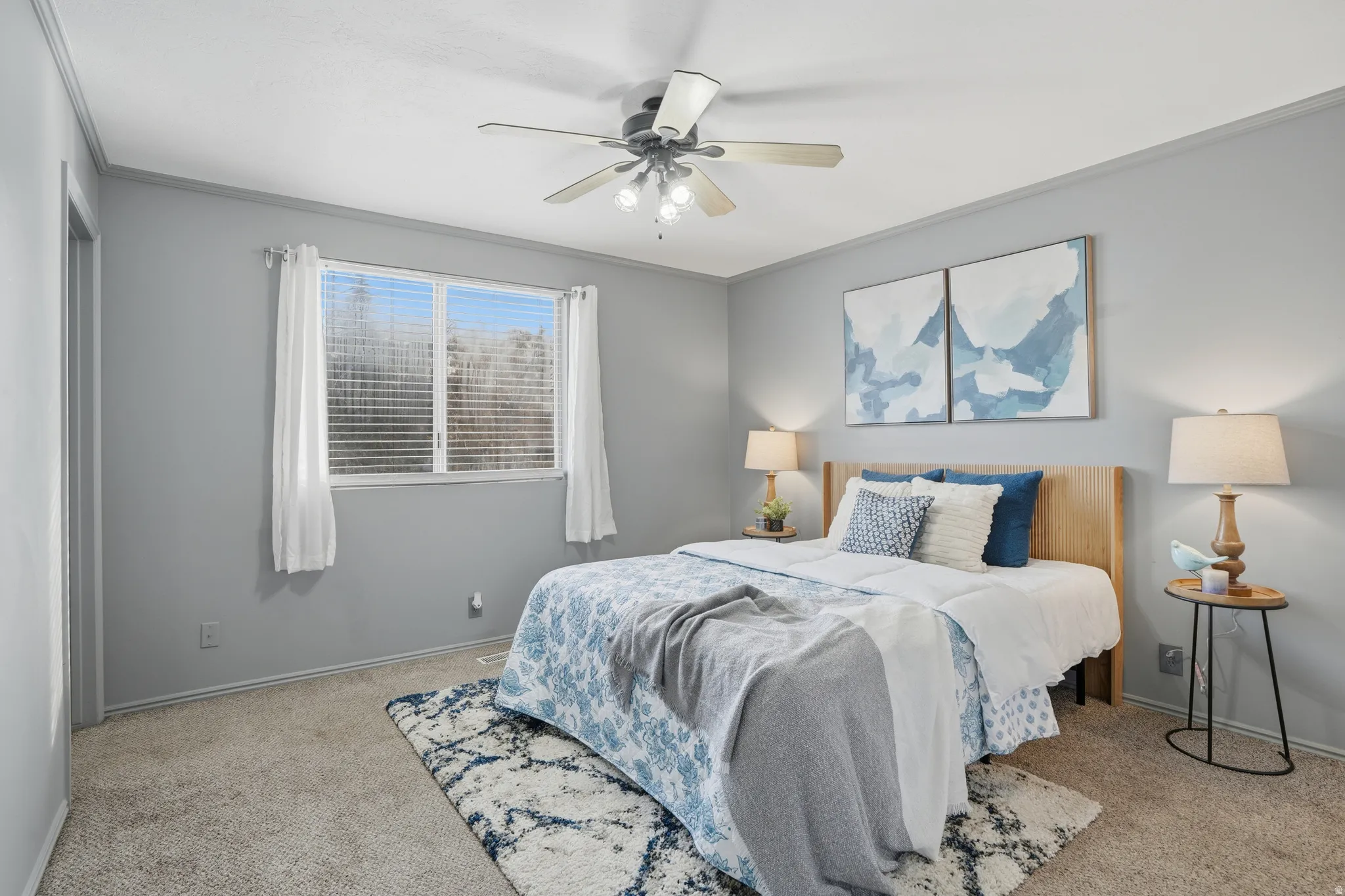 Carpeted bedroom featuring ceiling fan and baseboards