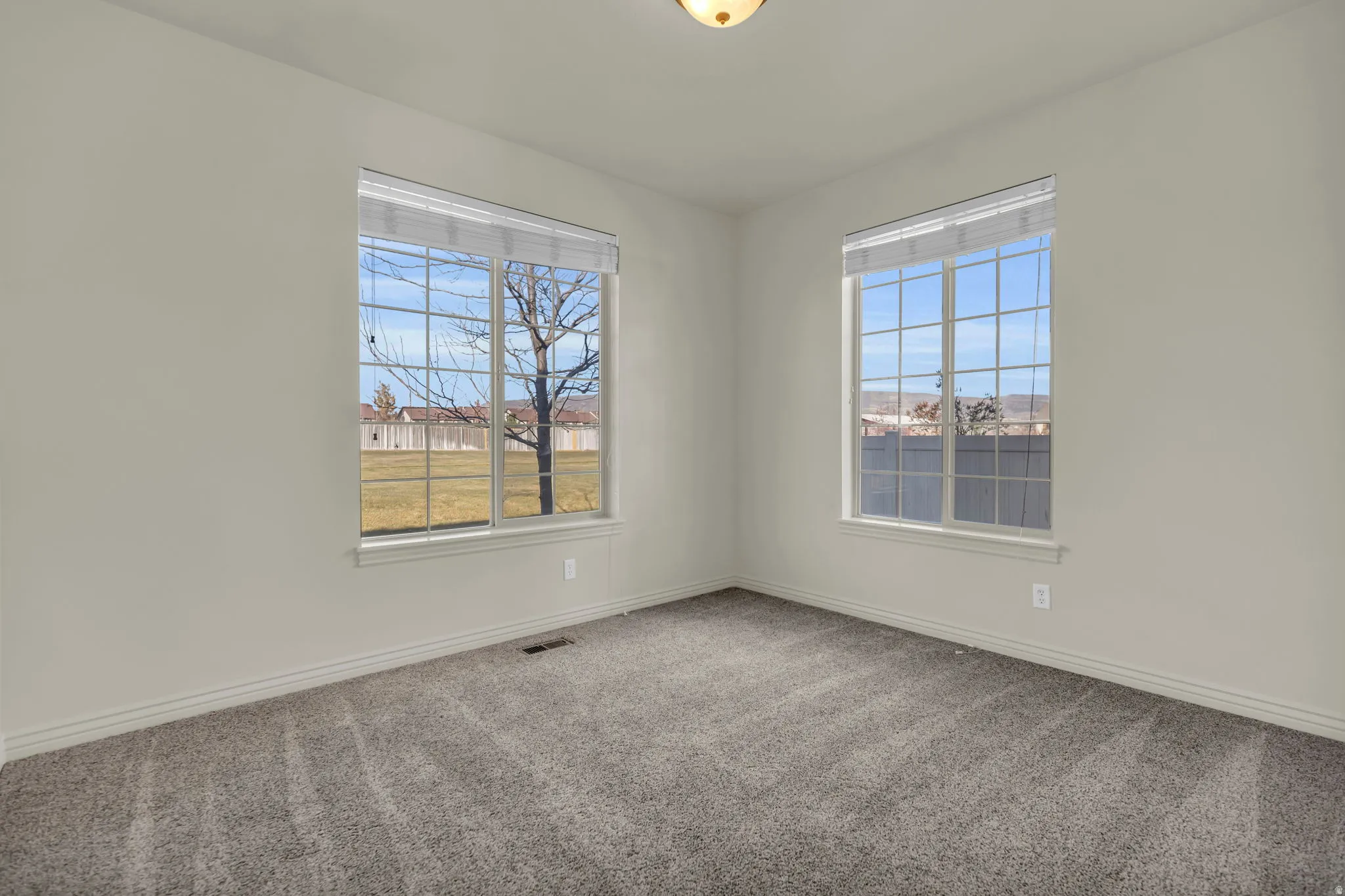 Unfurnished room with carpet and baseboards