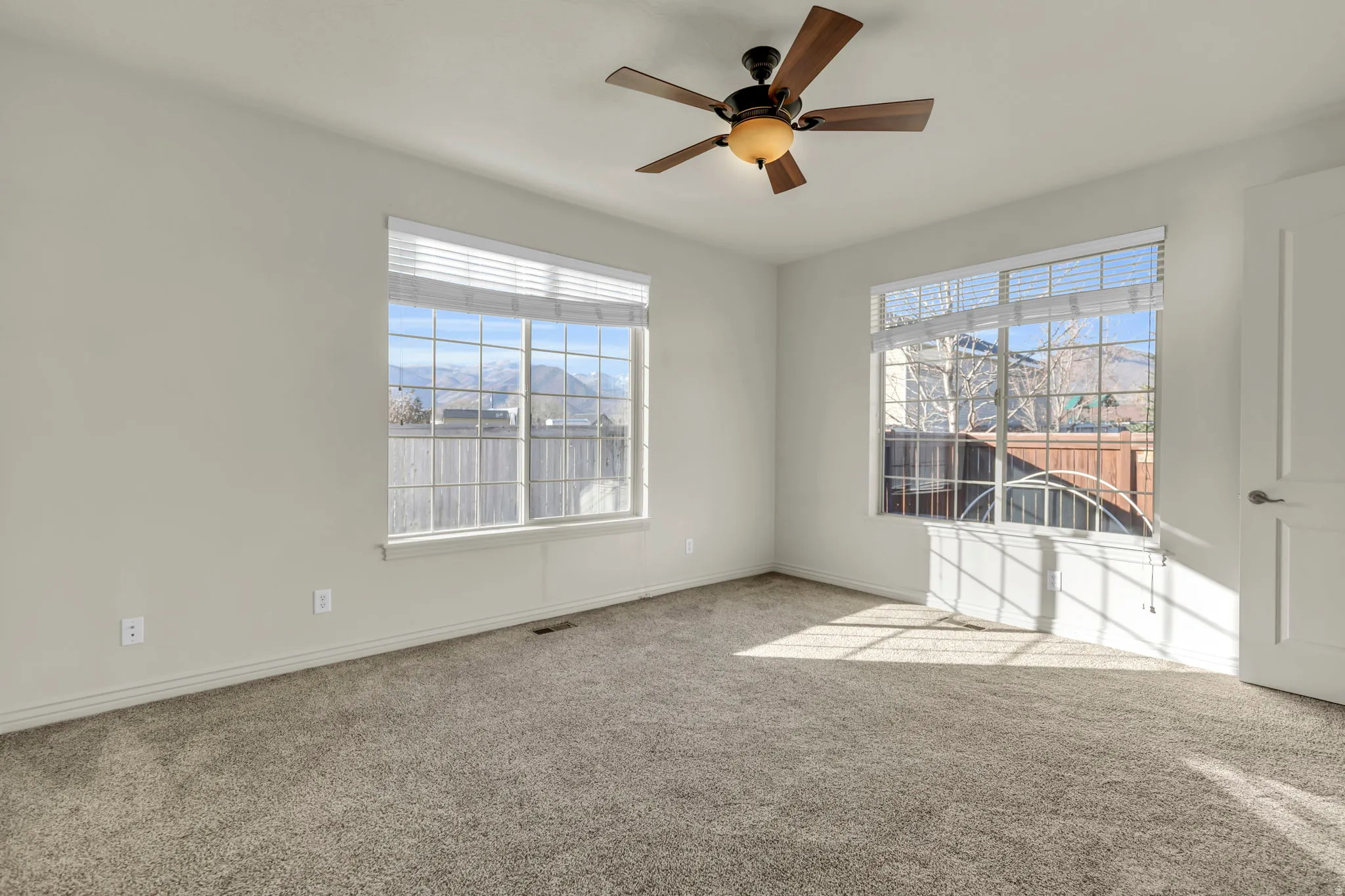 Spare room with carpet floors and a ceiling fan