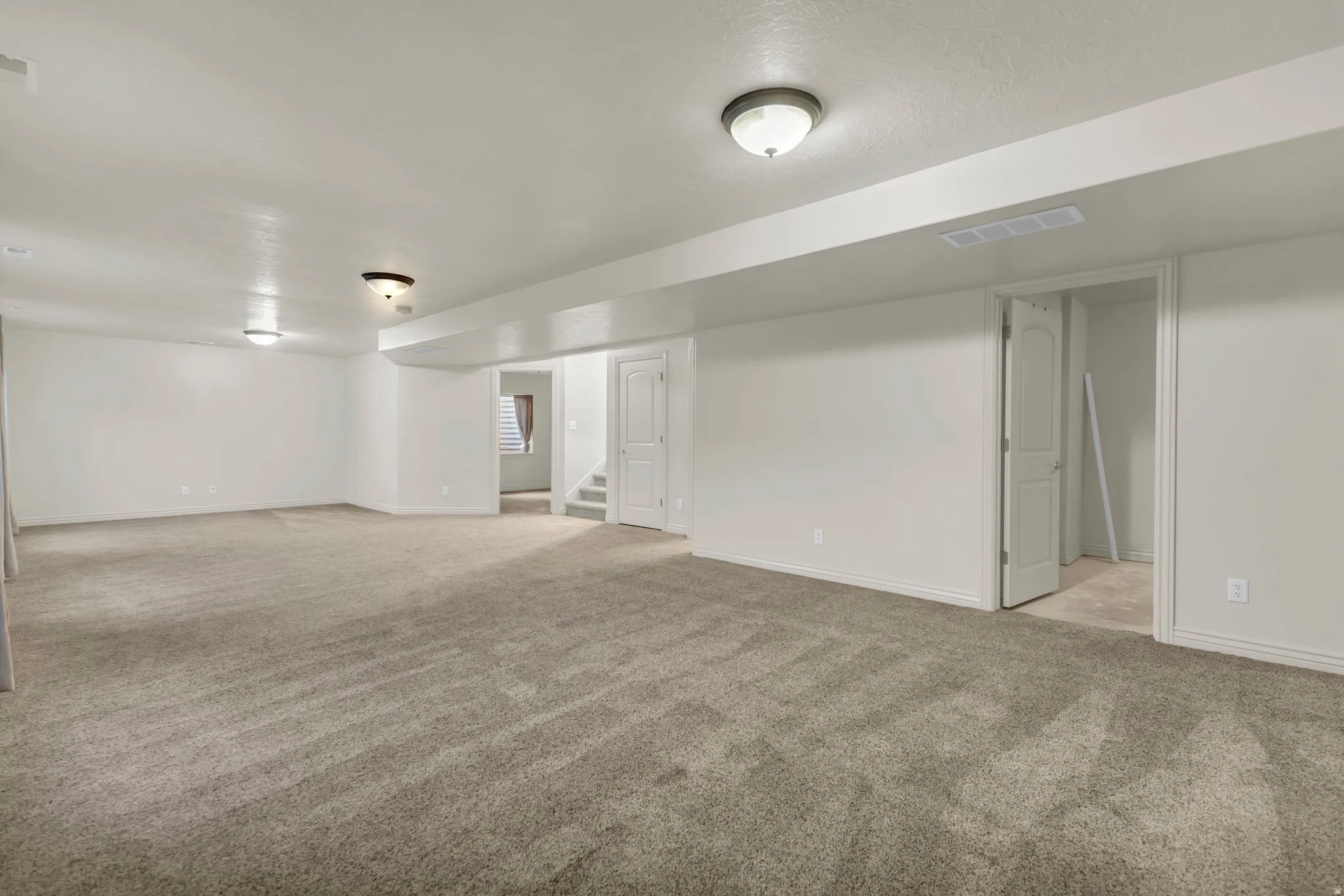 Finished basement featuring light carpet