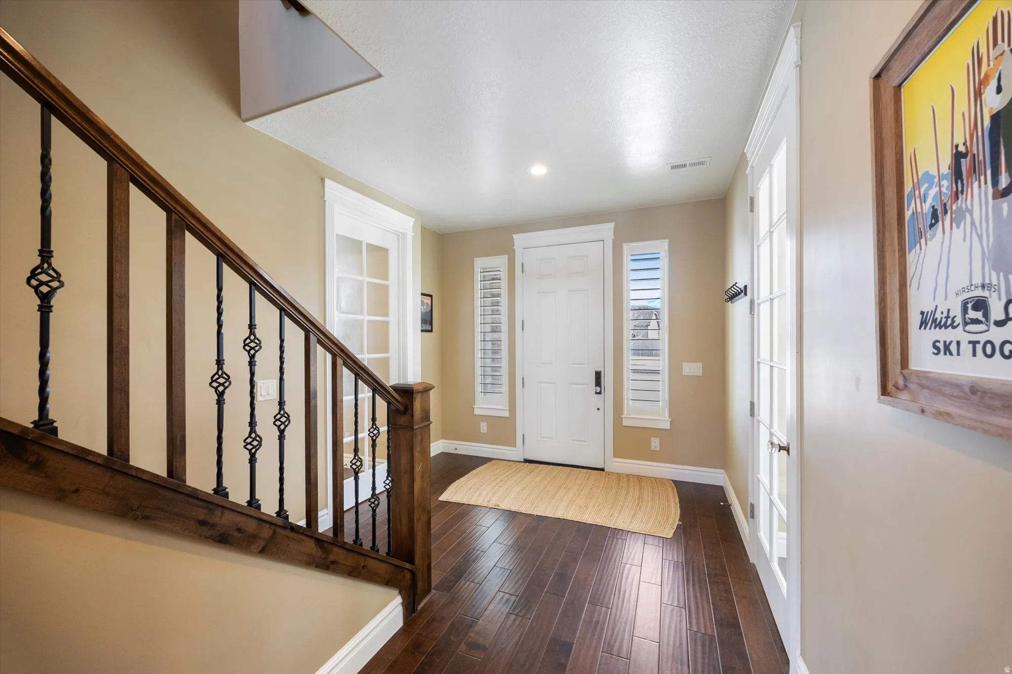 Foyer entrance featuring dark wood finished floors and recessed lighting