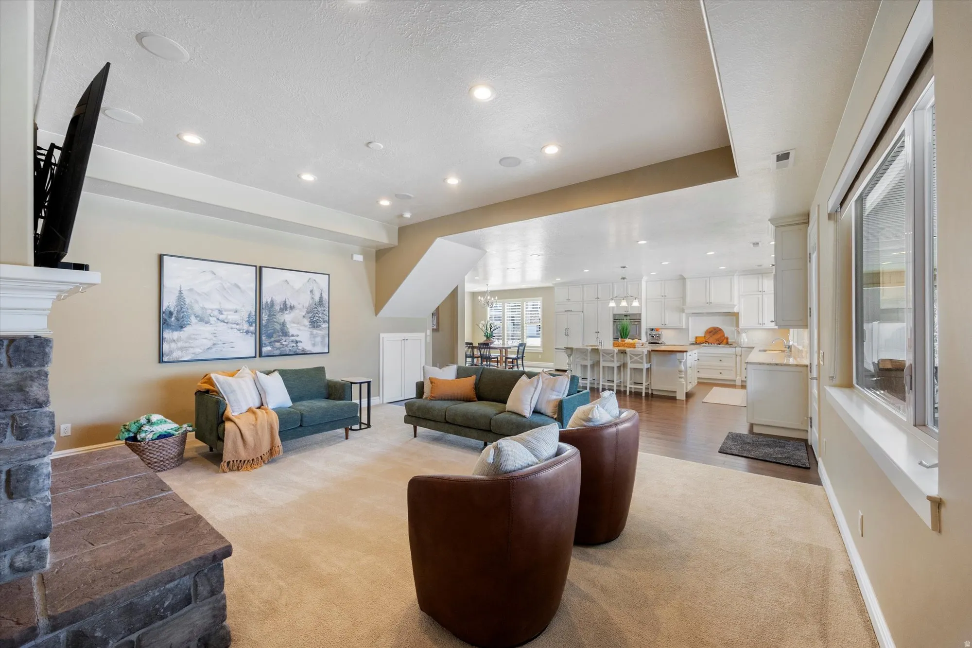 Living room with recessed lighting, light carpet, and a fireplace