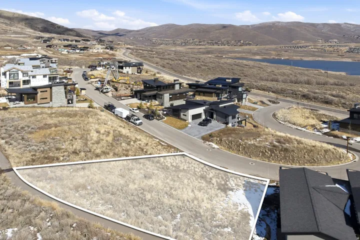 Aerial view of property's location with a mountain backdrop and nearby suburban area