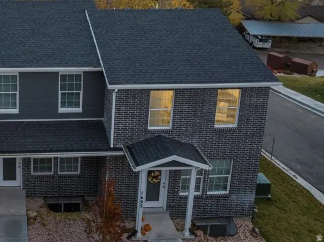 View of front of house with a mountain view and brick siding