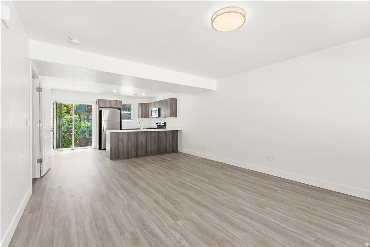 Unfurnished living room with light wood-style floors and recessed lighting