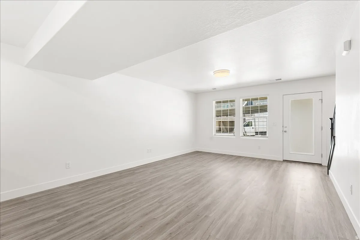 Empty room with light wood-type flooring and baseboards