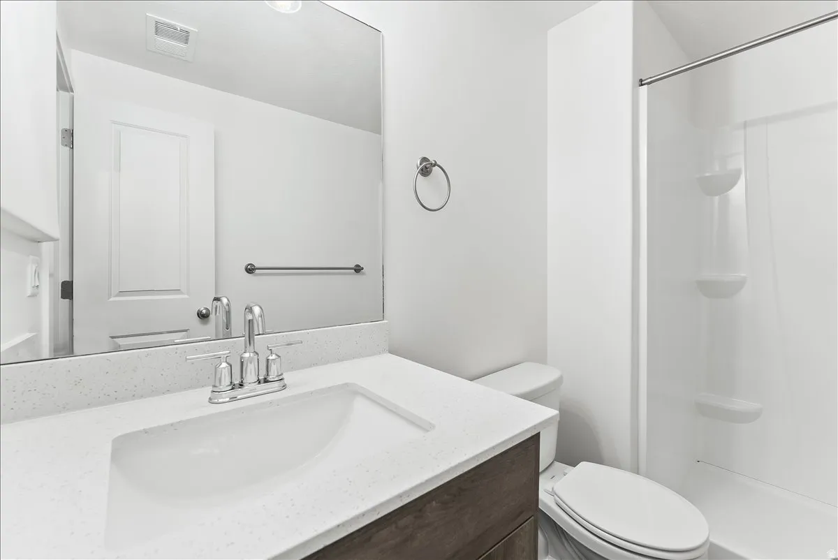 Full bath featuring vanity and a stall shower