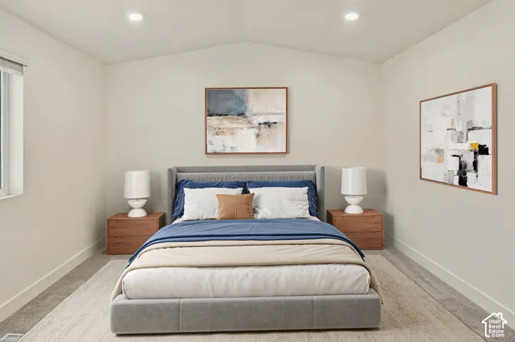 Vaulted ceiling, recessed lighting, and a large window