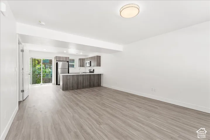 Unfurnished living room with light wood-style floors and recessed lighting